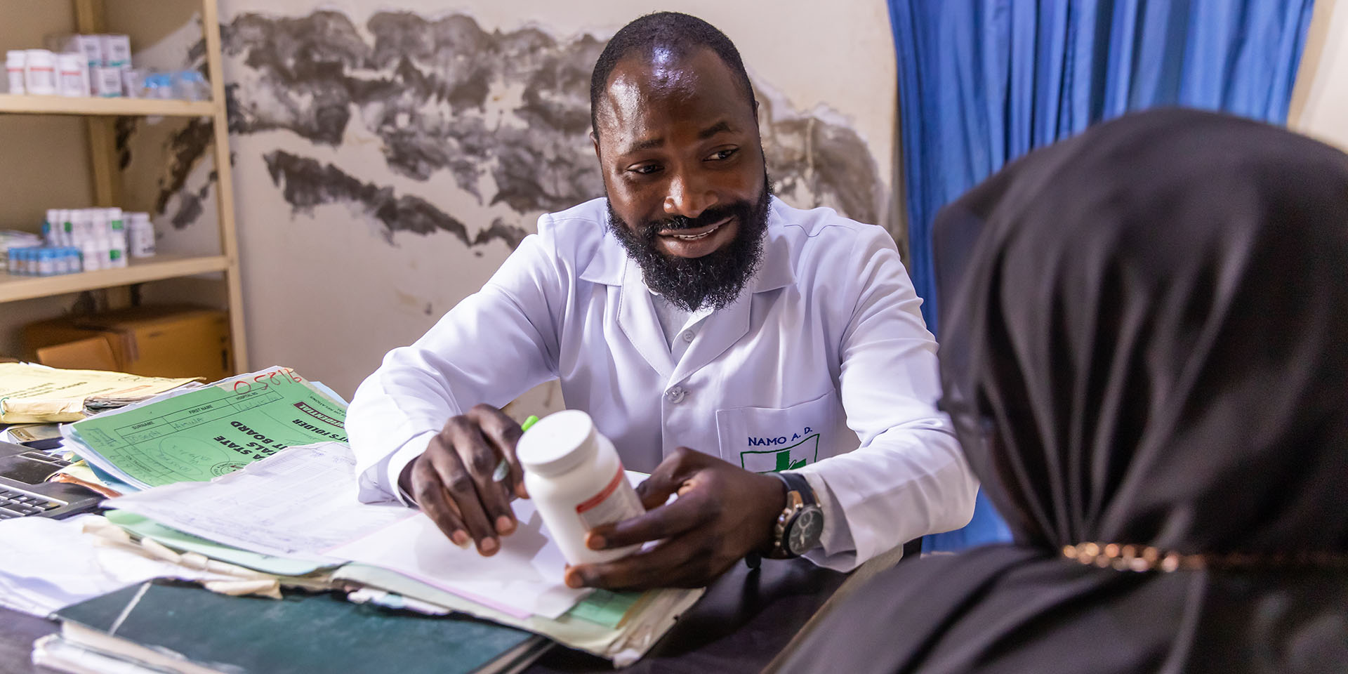 Doctor speaking to patient about HIV medicine in Nigeria