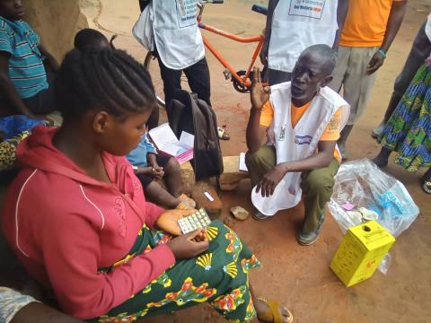 CHW Kasakula Godfrey explaining to community patient Chomba Karen about how to take her malaria treatment medication in Felushi Village under Kandeke zone of Kefulwa RHC catchment. Photo Credit: GHSC-PSM